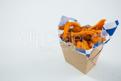 Close up of spicy French fries in carton box