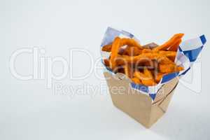 Close up of spicy French fries in carton box