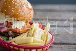 Close up of French fries and cheeseburger in basket