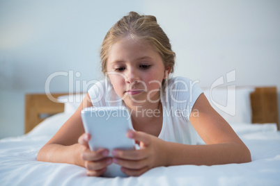 Close up of girl using smartphone on bed