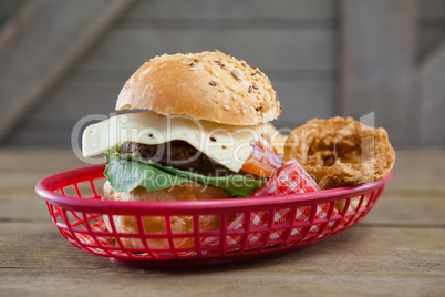 Hamburger and onion rings in basket