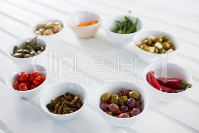 Marinated olives and vegetables on white background