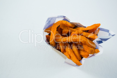 Overhead veiw of spicy French fries in carton box