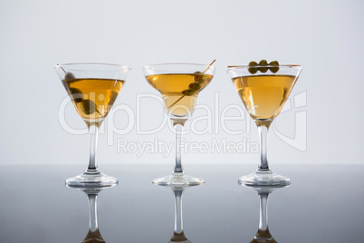 Cocktail with olives on table