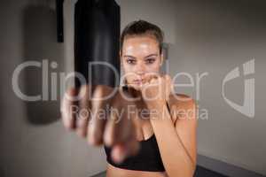 Female boxer practicing boxing in fitness studio
