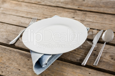Close up of plate and cutlery with napkin