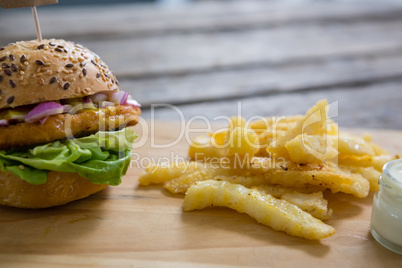 Close up of burger and french fries with dip