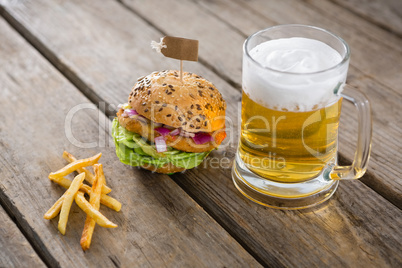 Close up of fries with hamburger and beer glass