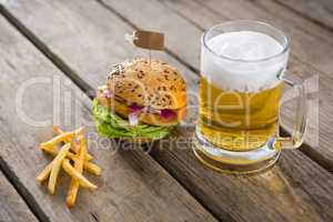 Close up of fries with hamburger and beer glass