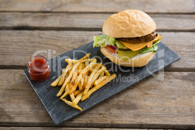 Cheeseburger with french fries and sauce