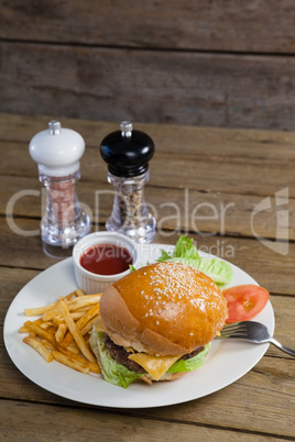 Burger, french fries, sauce in plate