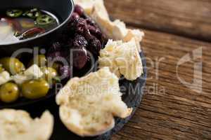 Pickled olives and vegetables surrounded with bread pieces