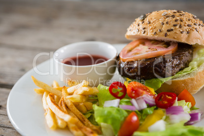 Salad with burger and french fries