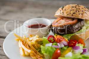 Salad with burger and french fries