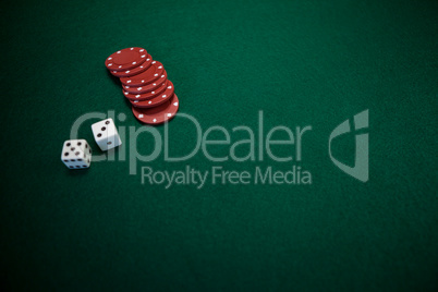 Pair of dice and casino chips on poker table