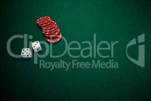 Pair of dice and casino chips on poker table