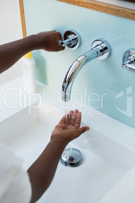 High angle view of boy washing hands in wash bowl