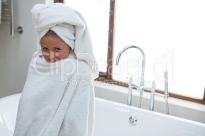 Portrait of smiling girl sitting on bathtub