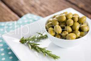 Marinated olives with rosemary on tray