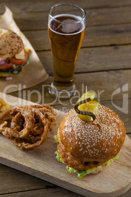 Hamburger and onion ring with glass of beer