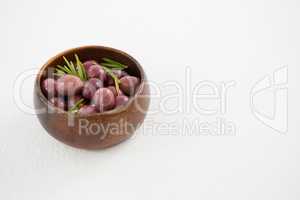Pickled olives in wooden bowl