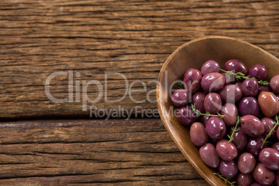 Marinated olives in wooden bowl