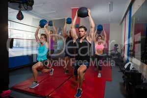 Athletes practicing lunge with exercise ball