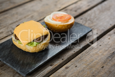 Cheese and meat with buns on slate