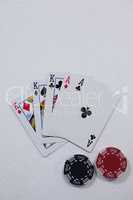 Playing cards and casino chips on white background