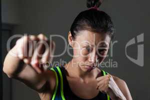 Determined woman practicing boxing in fitness studio