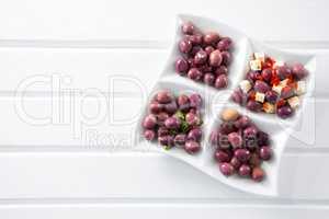 Marinated olives with herbs and spice in plate on table