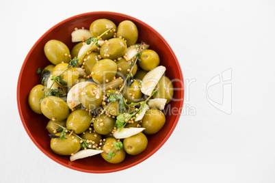 Marinated olives with garlic and herbs in bowl