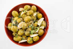 Marinated olives with garlic and herbs in bowl