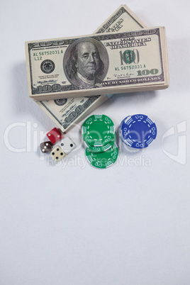 US dollars, dice and casino chips on white background