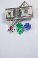 US dollars, dice and casino chips on white background