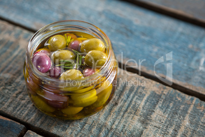 Close-up of marinated olives in jar