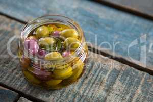 Close-up of marinated olives in jar