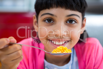 Close-up of portrait of girl holding cereal in spoon