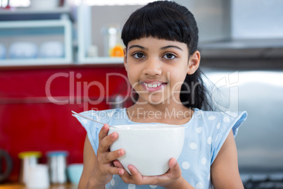 Portrait of smiling girl holding bowl