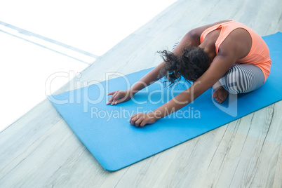 High angle view of girl exercising on exercise mat