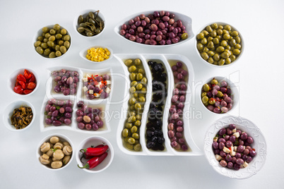 Various pickled olives on white background