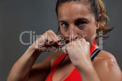 Determined woman practicing boxing in fitness studio