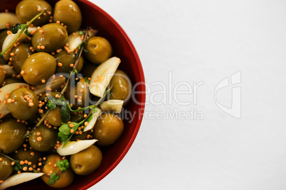 Marinated olives with garlic and herbs in bowl