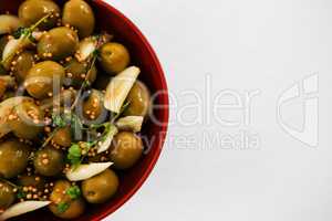 Marinated olives with garlic and herbs in bowl