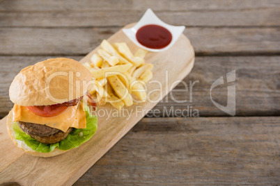 High angle view of french fries with burger and sauce
