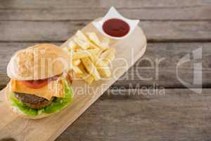 High angle view of french fries with burger and sauce