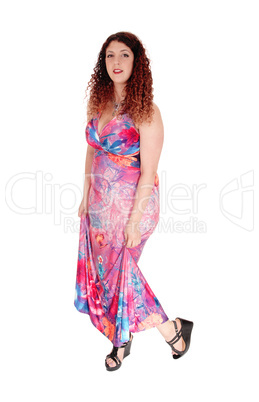 Woman standing in long dress.