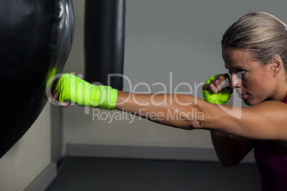 Woman practicing boxing in fitness studio