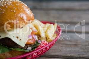 Close up of cheeseburger and French fries in basket