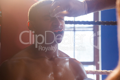 Trainer applying cream on man face